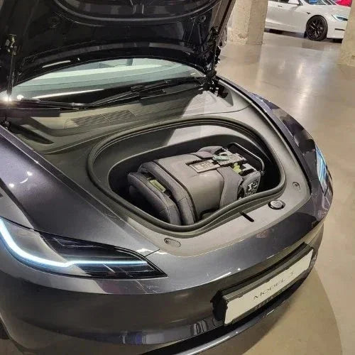 TinySeats Two extended rear-facing car seat in the frunk of a Tesla