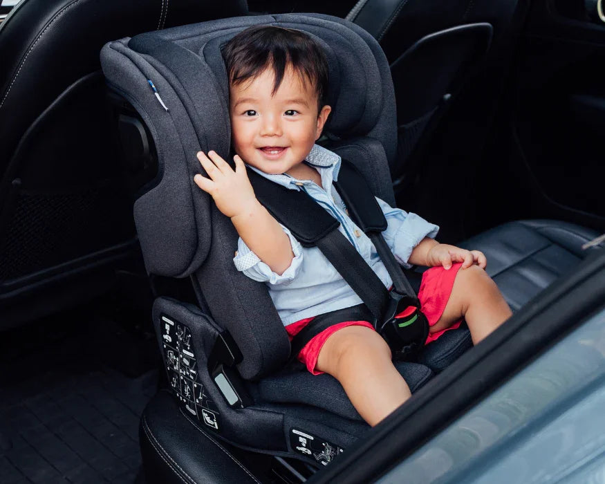 Asian younger toddler in a car seat inside a vehicle